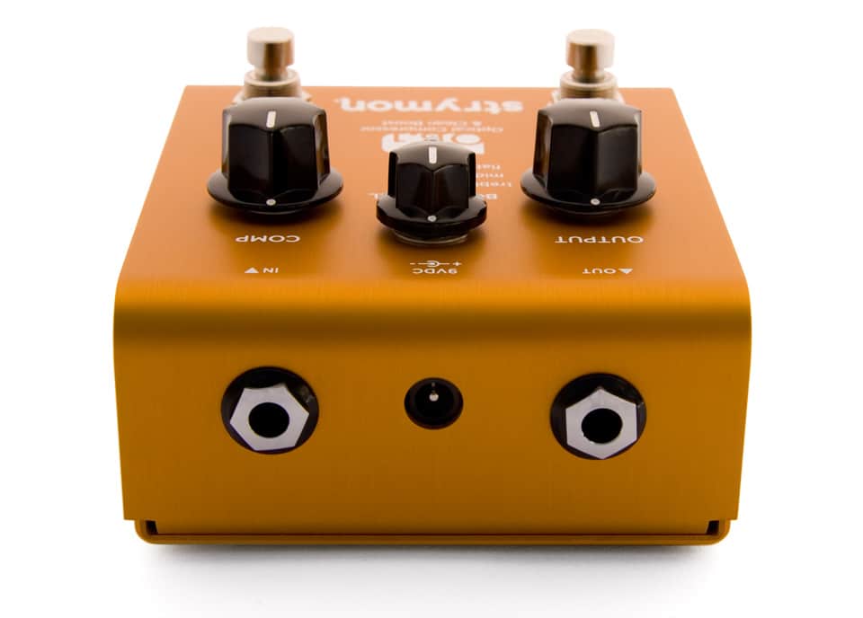 rear view orange guitar pedal showing 2 chrome nose input jacks, recessed DC jack and side profile view of black control knobs