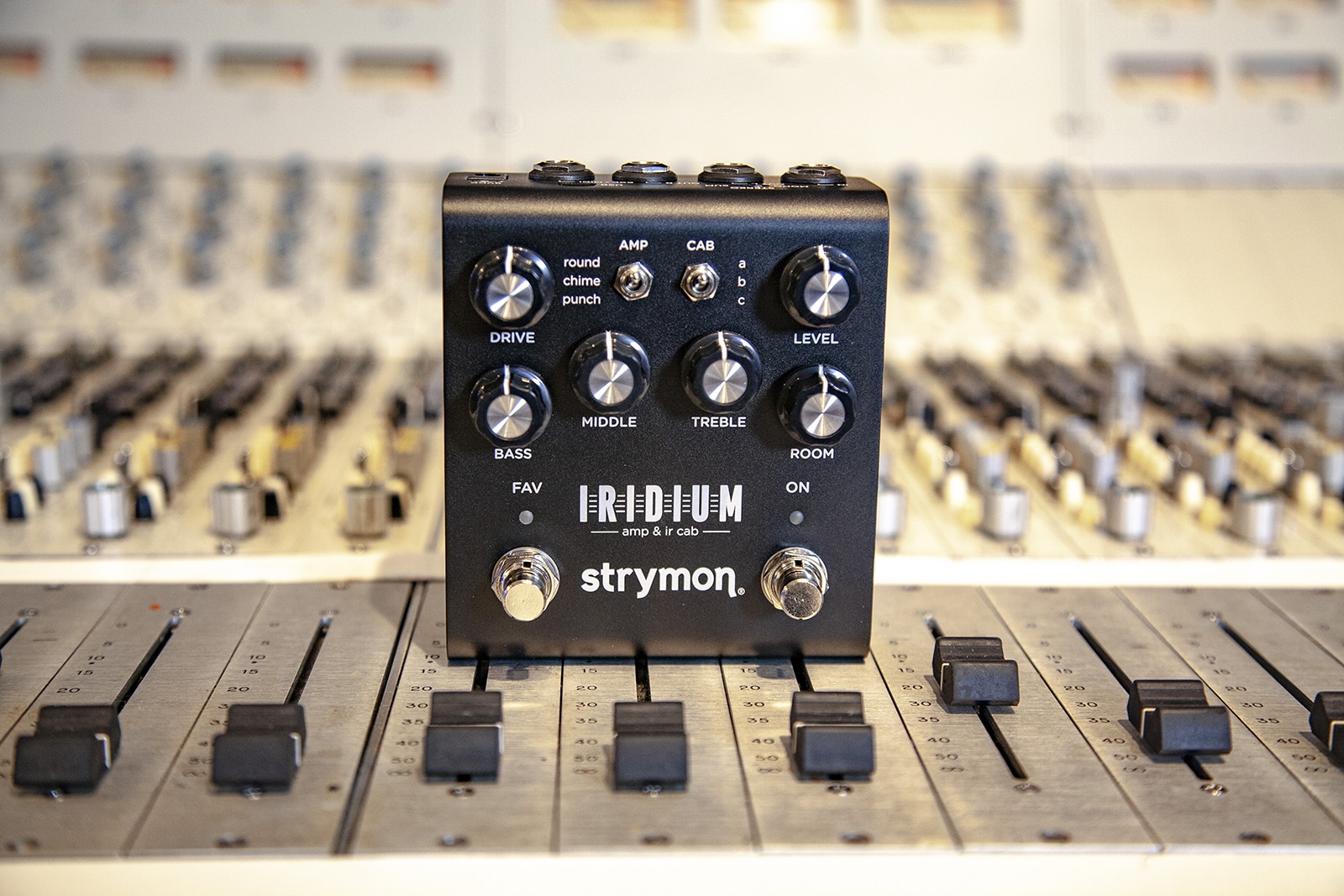 Iridium sitting on top of a recording console.