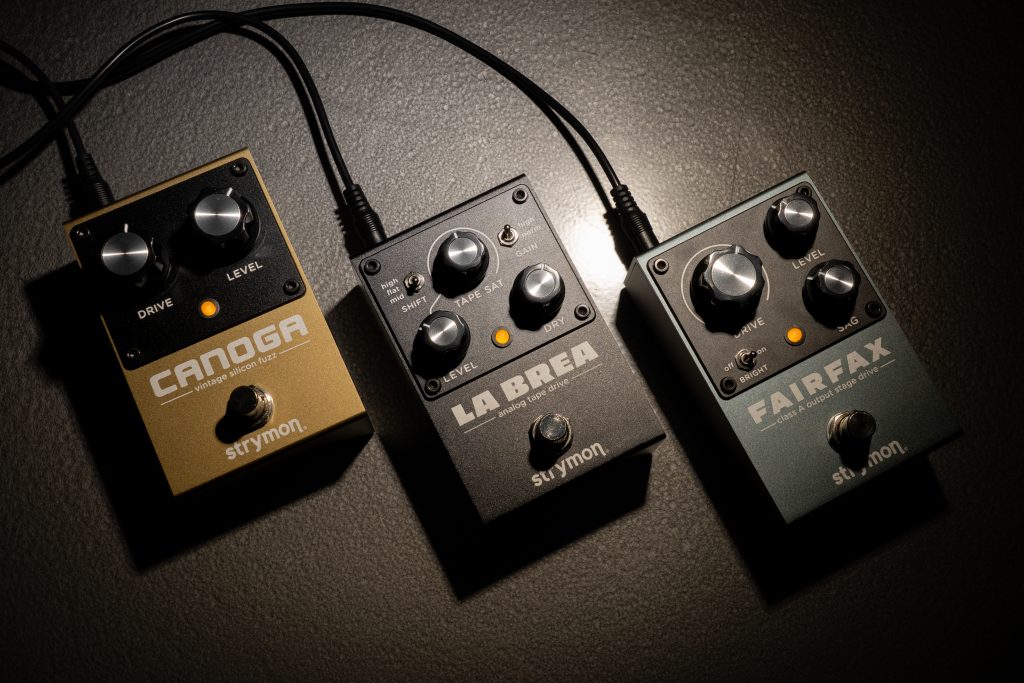 La Brea sitting next to a Strymon Fairfax and Strymon Canoga on a metal surface.