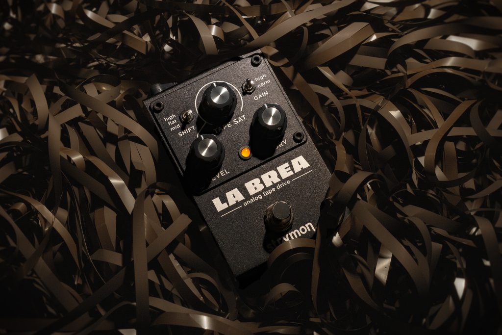 Strymon La Brea pedal sitting on a pile of magnetic tape.